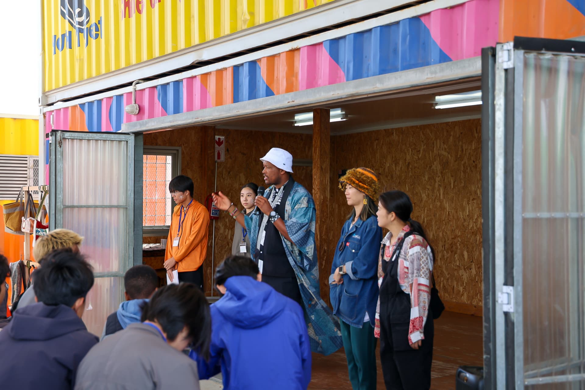 Community speakers and guests sharing a conversation at the gathering