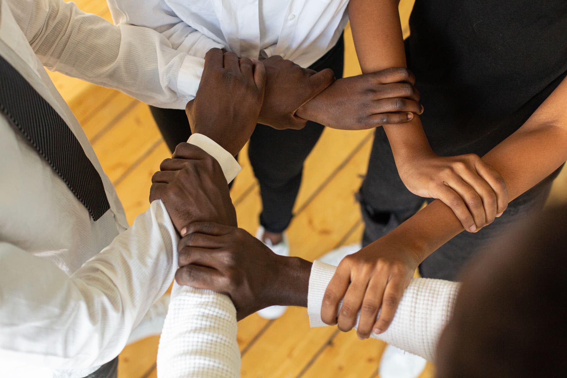 Hands joined together in the middle of a circle