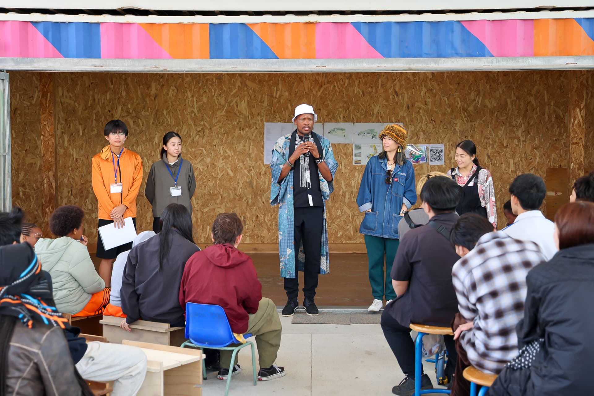 Local and visiting community members listening to speakers at a gathering